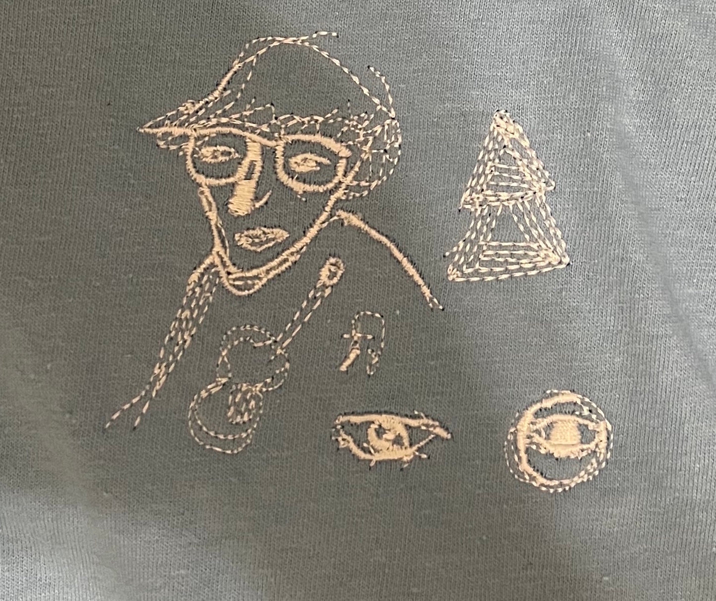 white embroidery on baby blue t-shirt